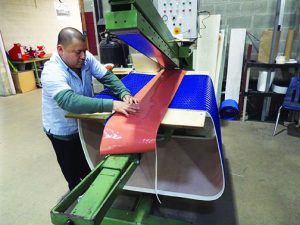 Francisco Mejia works with rolls of silicone as he creates toppings for O